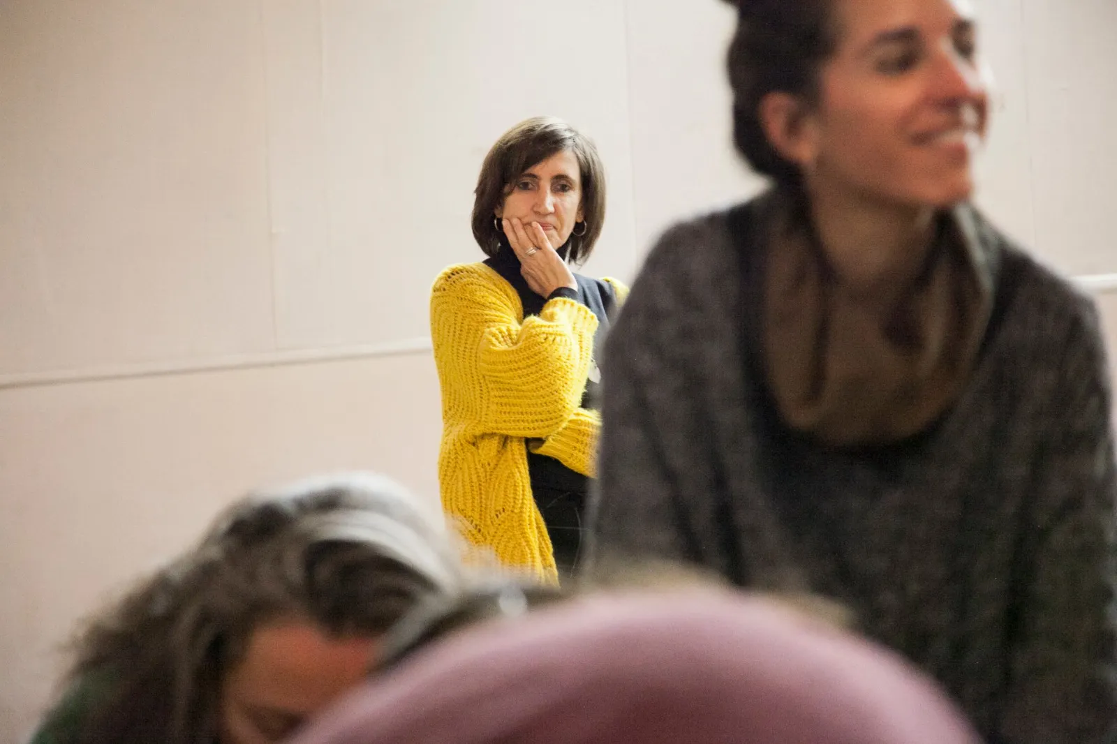 Alícia, amb jersei groc, somriu i parla amb el grup.